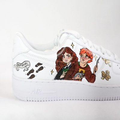 Weiße Sneakers mit handgezeichneten Illustrationen von Ron Weasley und Hermine Granger aus Harry Potter.